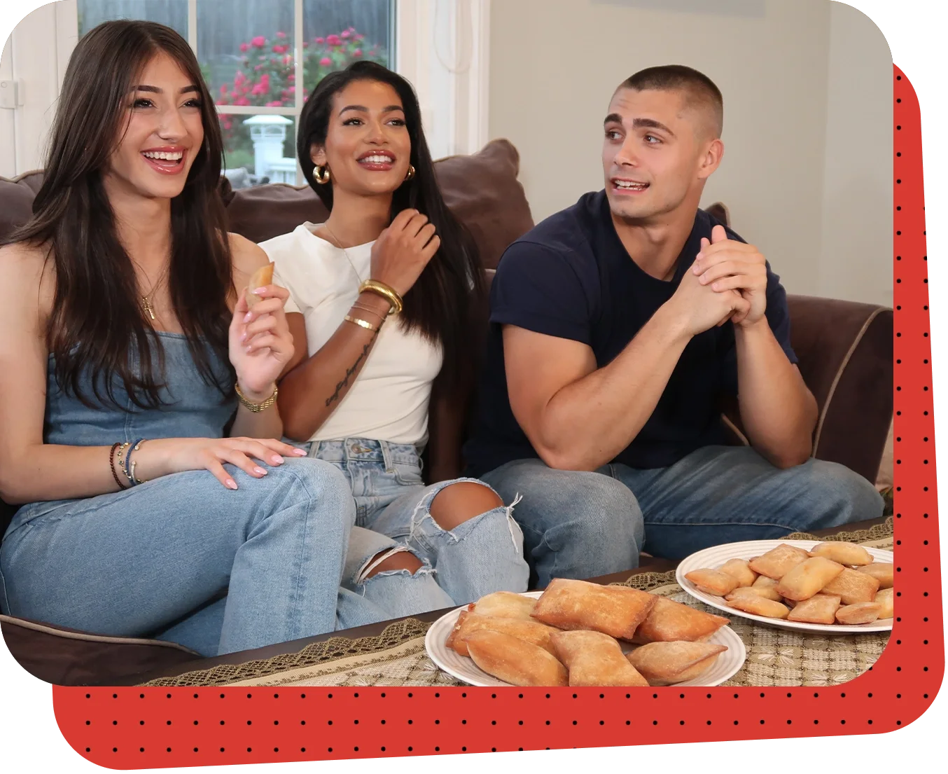 Three people sitting on a couch eating food.